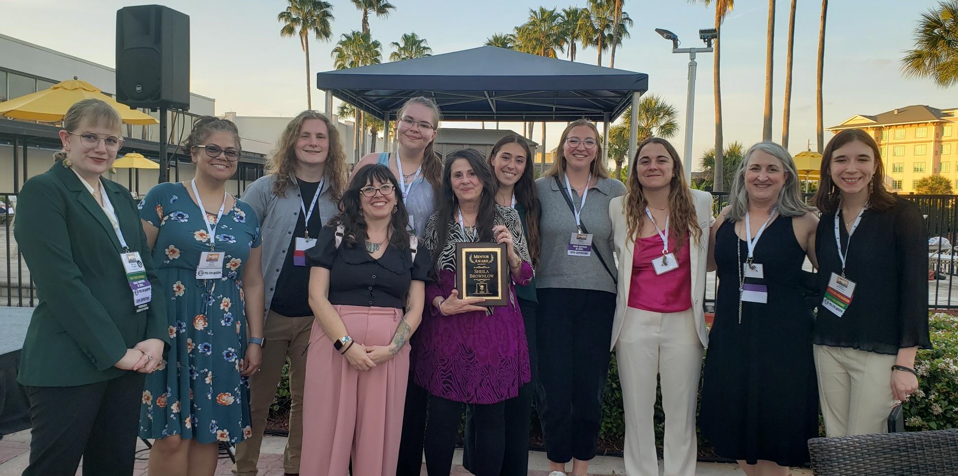 Dr. Sheila Brownlow poses with her award, Catawba students, and faculty