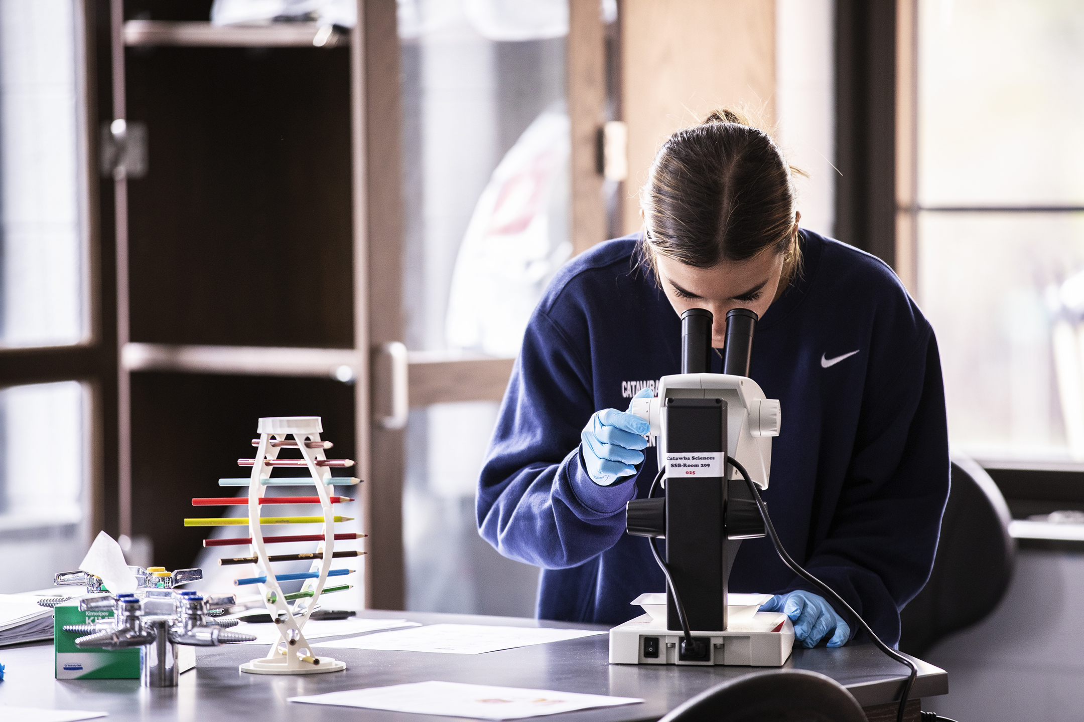 Student looking in Shuford Science Lab Microscope