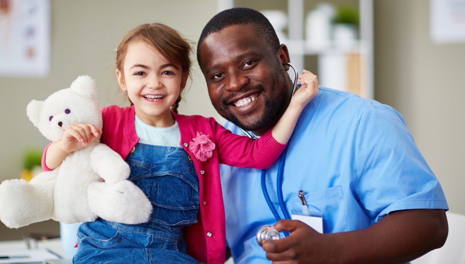 RN to BSN Nursing Student at Work with child and teddy bear