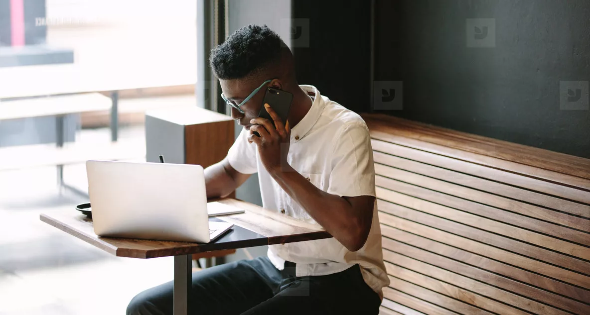 Online student on laptop in coffee shop