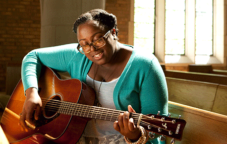 Quashona - Music Student playing guitar