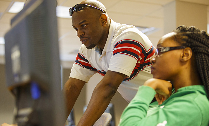 Earl Givens giving library assistance