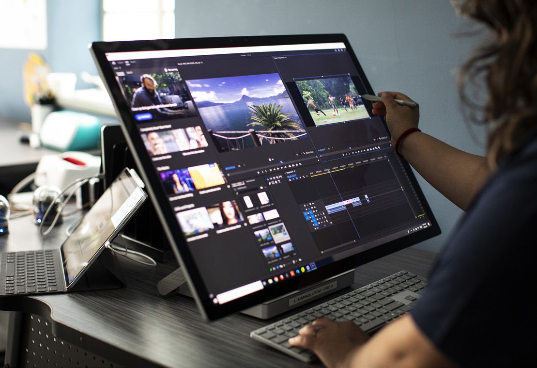 Student editing video on a laptop